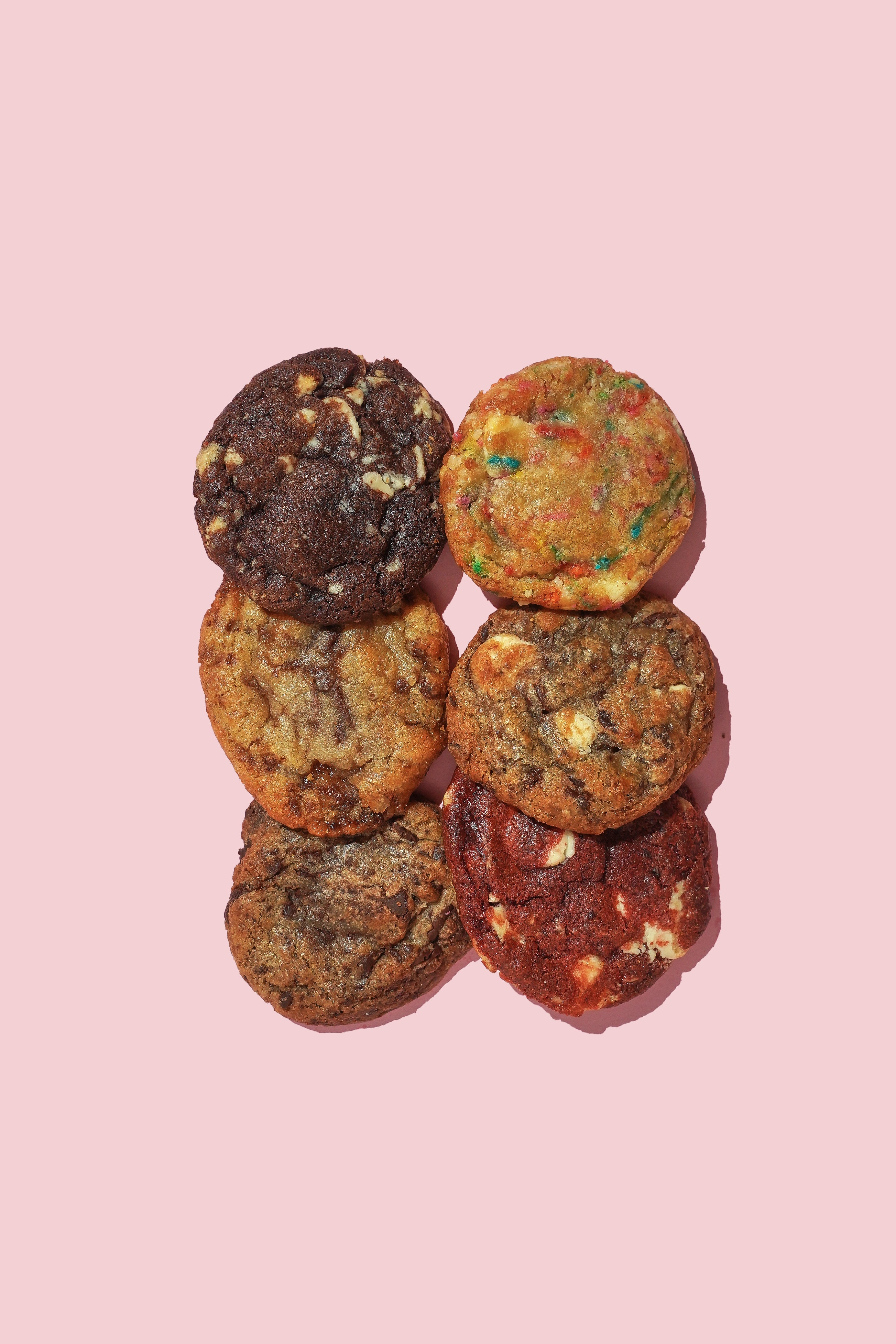 Assorted cookies on a pink background